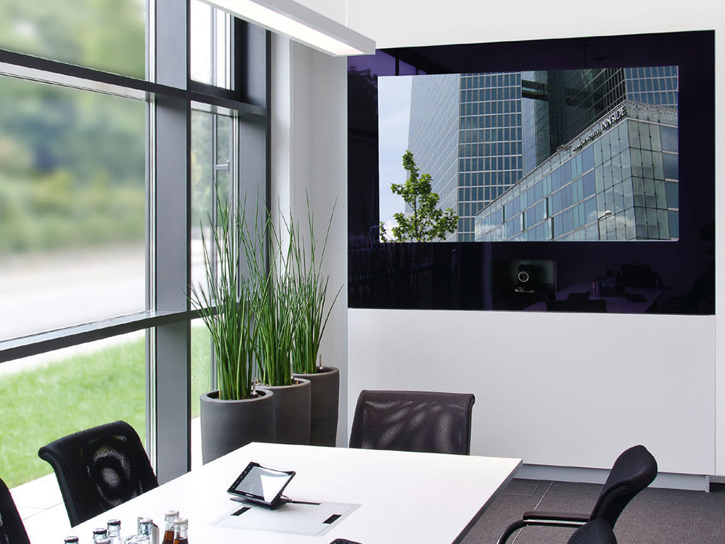 Media wall with video conferencing module in a conference room with meeting table