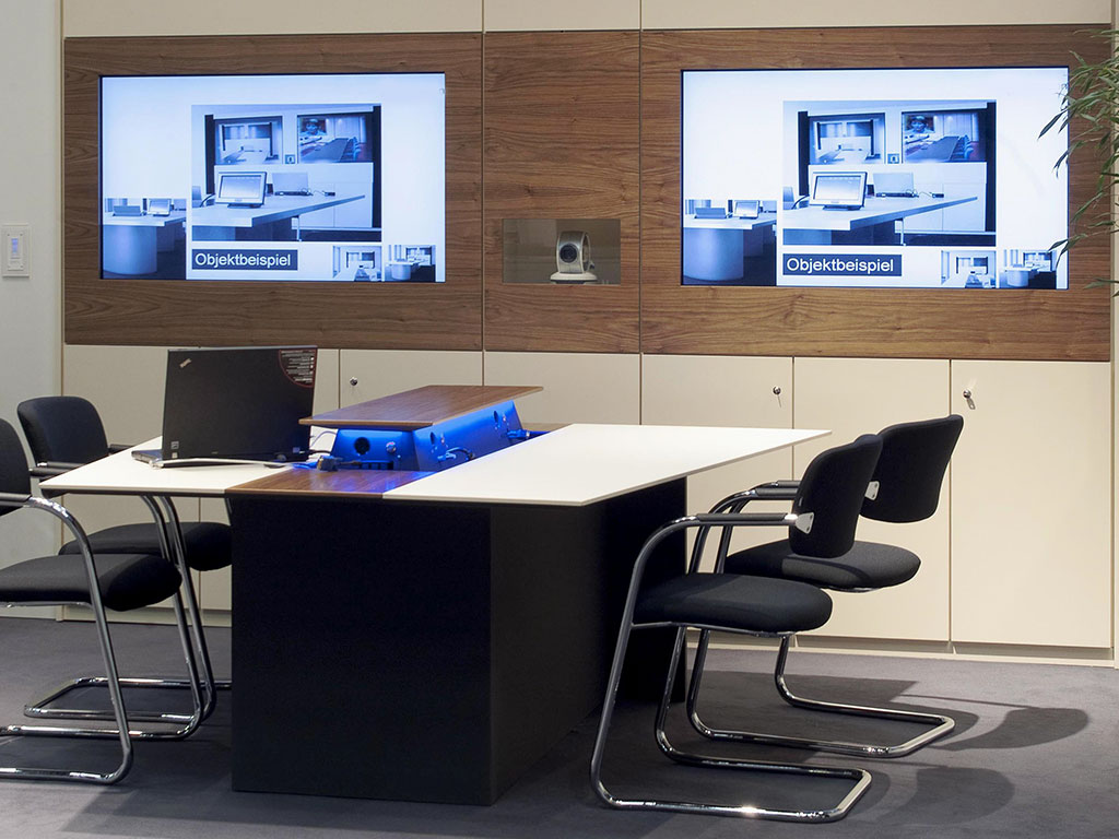 Media wall with two screens, video conference module and cabinets