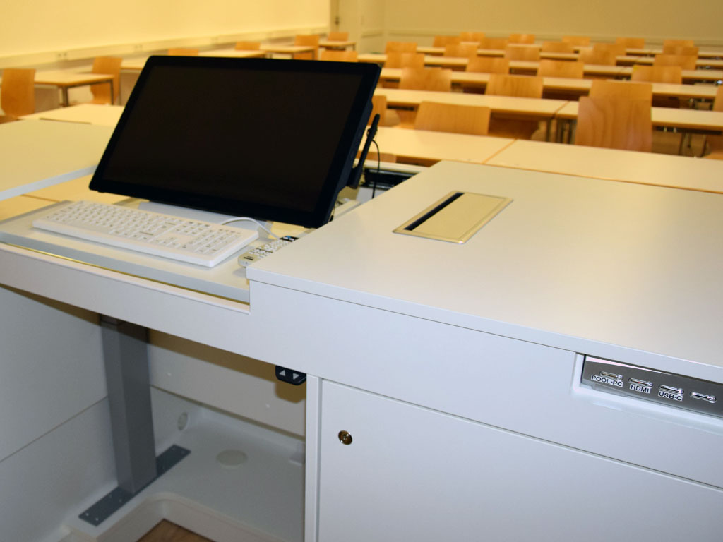 Detailed view of the teach.ruota lecturer's desk with user-integrated media control via technology cabinet.